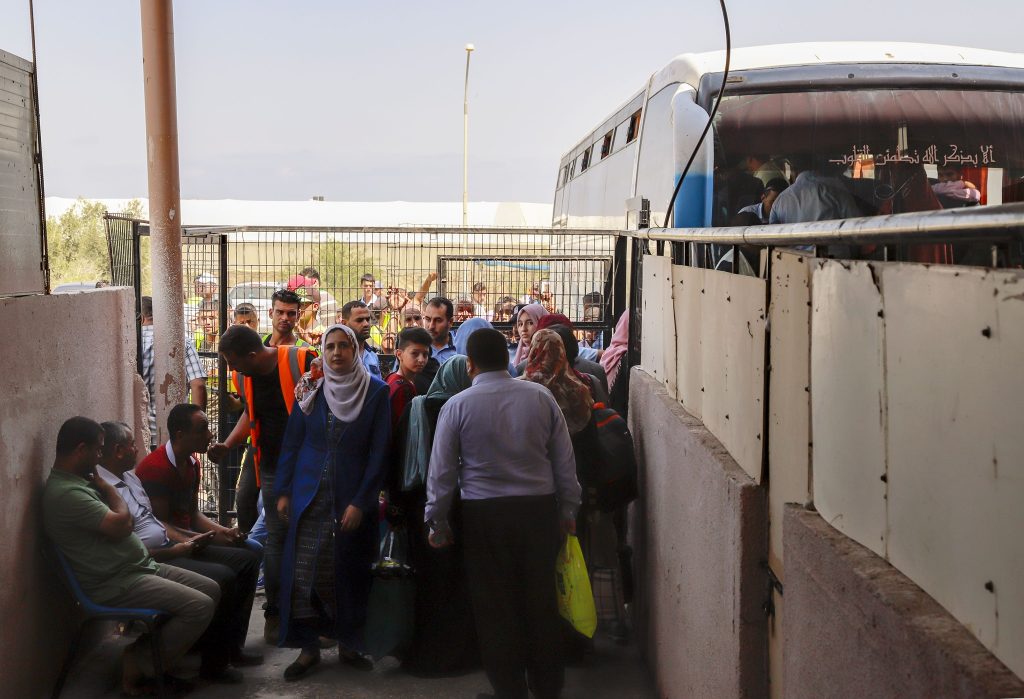 Gaza residents wait at a border crossing.