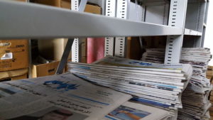 Stack of Arabic newspapers on a shelf