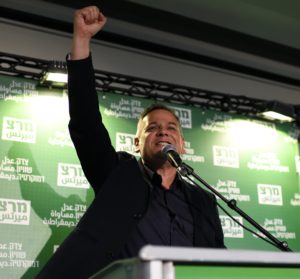 Horowitz with his fist in the air at a podium